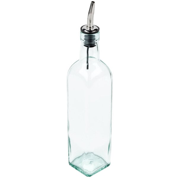 A clear glass olive oil cruet with a metal pourer spout.