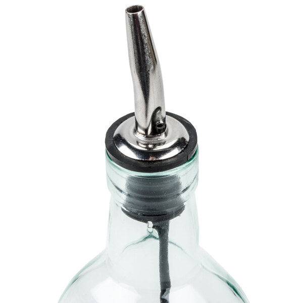 A glass olive oil cruet with a metal pourer attached to the top.