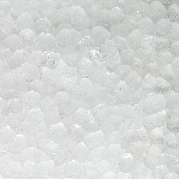 A close-up view of clear nugget ice produced by a commercial ice machine.