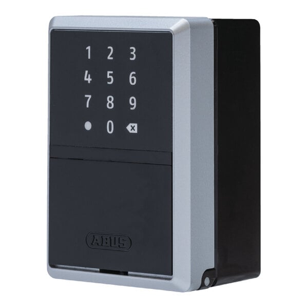 A wall-mounted ABUS KEYGARAGE One 787 smart key storage lockbox with a numeric keypad.