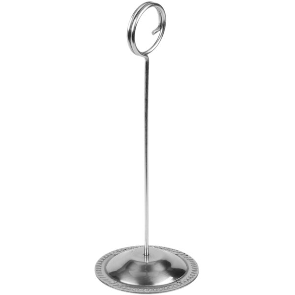 A stainless steel menu or card holder with a circular base and a looped top.