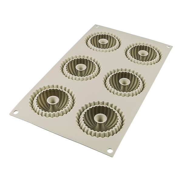 A silicone baking mold with six ridged donut-shaped cavities.