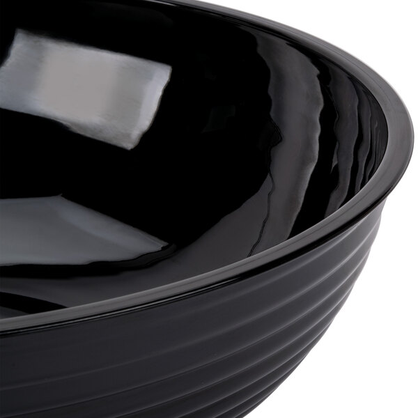 A large black round ribbed plastic bowl.