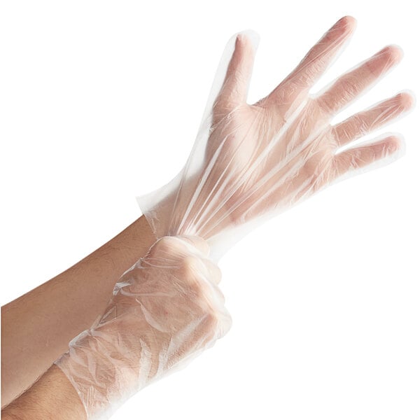 A pair of clear disposable poly gloves being worn on hands.