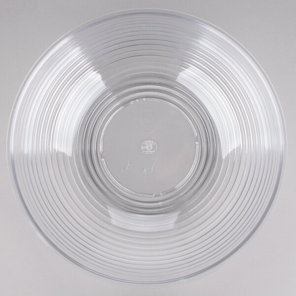 A large clear round ribbed plastic bowl.