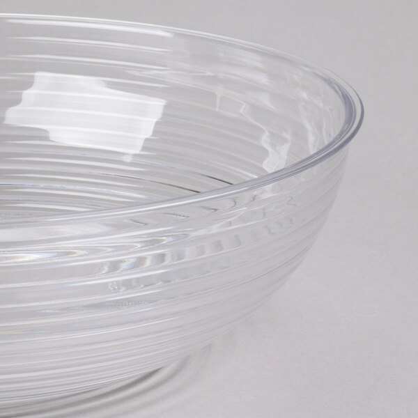 A large clear round ribbed plastic bowl.