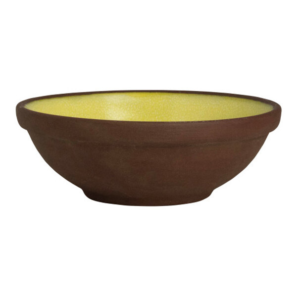 A round stoneware ramekin with a brown exterior and a yellow interior.