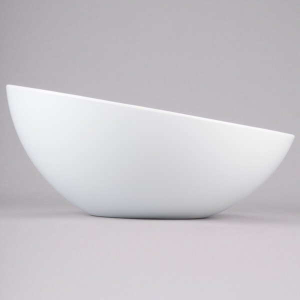 A large white round melamine bowl with a slanted rim.