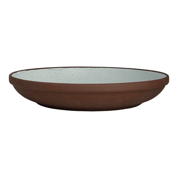 A round, deep stoneware plate with a brown exterior and a speckled light interior.