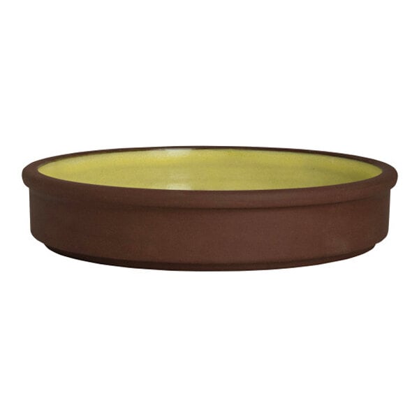 A round, stackable deep stoneware tray with a brown exterior and saffron yellow interior.