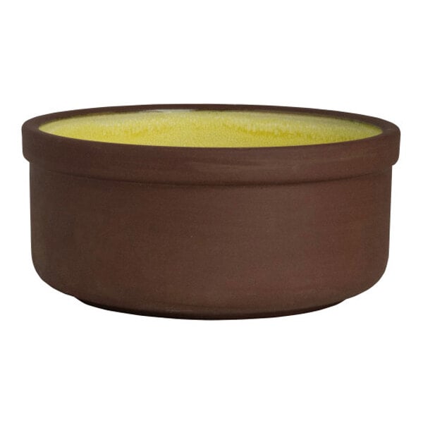 A round stoneware bowl with a brown exterior and a saffron yellow interior.