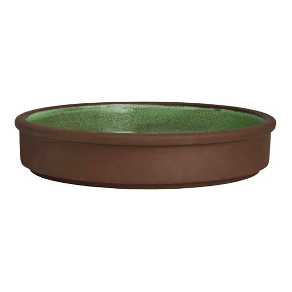 A round, brown stoneware tray with a green interior, designed to be stackable and deep.