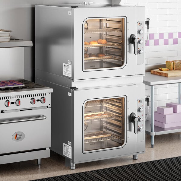 A double-stacked, stainless steel, full-size electric combi oven with manual controls, designed to hold six pans per unit.