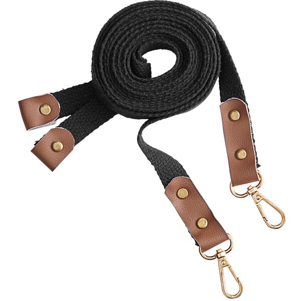 A pair of black charcoal straps with brown leather accents and metal clips, designed for grilling aprons.