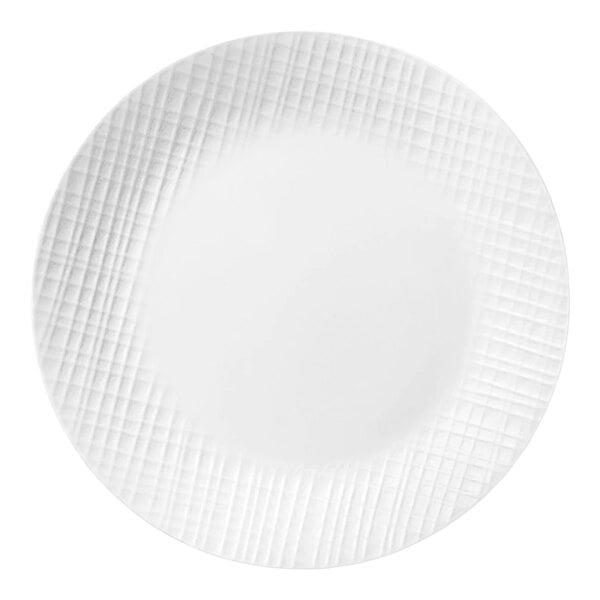 A round bright white glass plate with an embossed woven pattern on the rim.