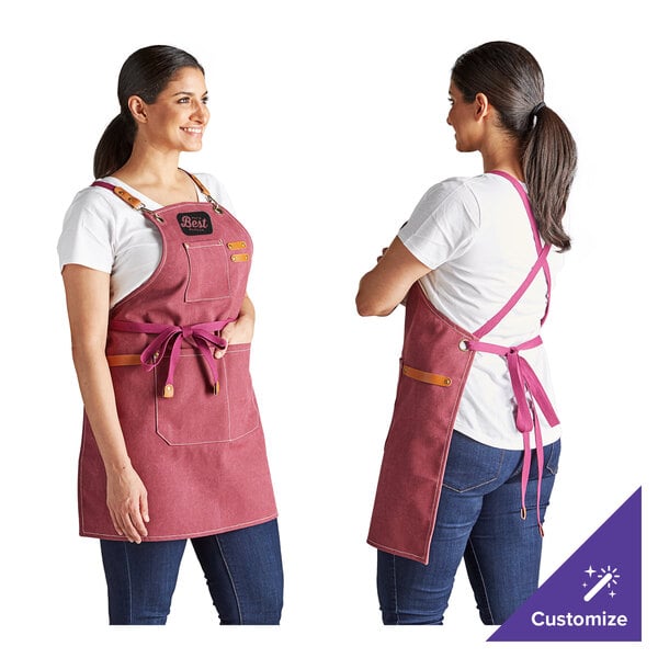 A customizable heavy weight canvas cross-back bib apron in wine color with three pockets, shown from the front and back.