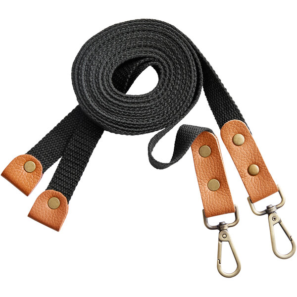 A pair of black cross-back replacement straps with tan leather accents and metal clips.