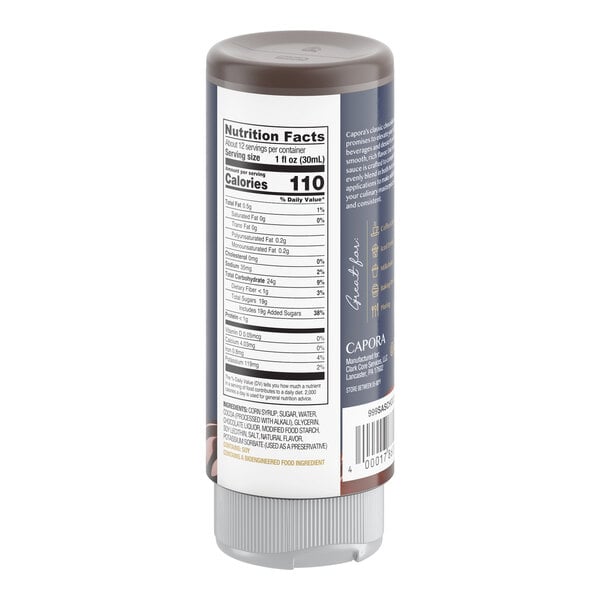 A plastic squeeze bottle of Capora chocolate flavoring sauce with a nutrition facts label and ingredient list visible on the back.