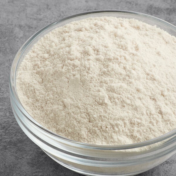 A glass bowl filled with vanilla protein powder.