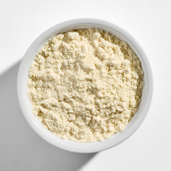 A white bowl filled with vanilla protein powder.