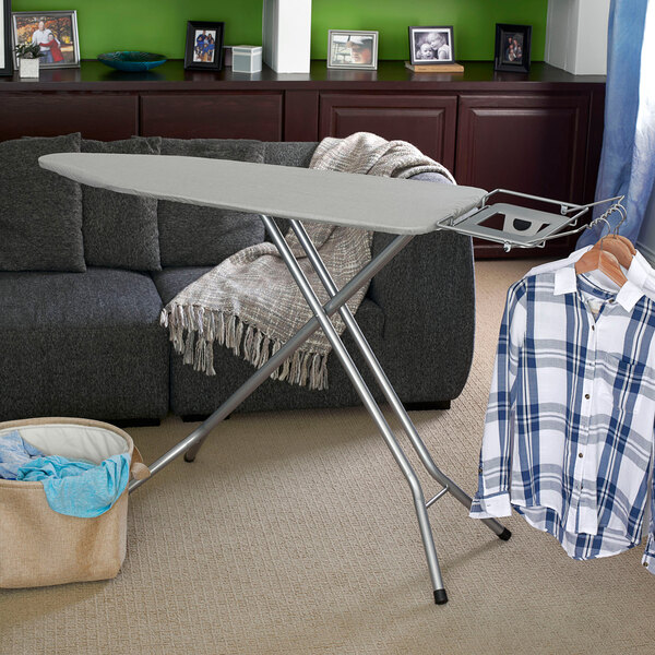 A silver steel top ironing board with a cotton cover and an iron rest.