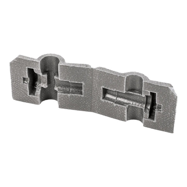 A molded gray foam cover for an expansion valve with custom cutouts.