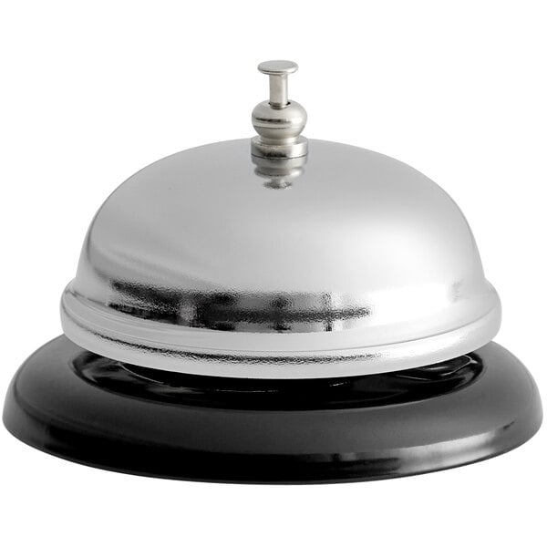 A stainless steel call bell with a black base and a push button on top.