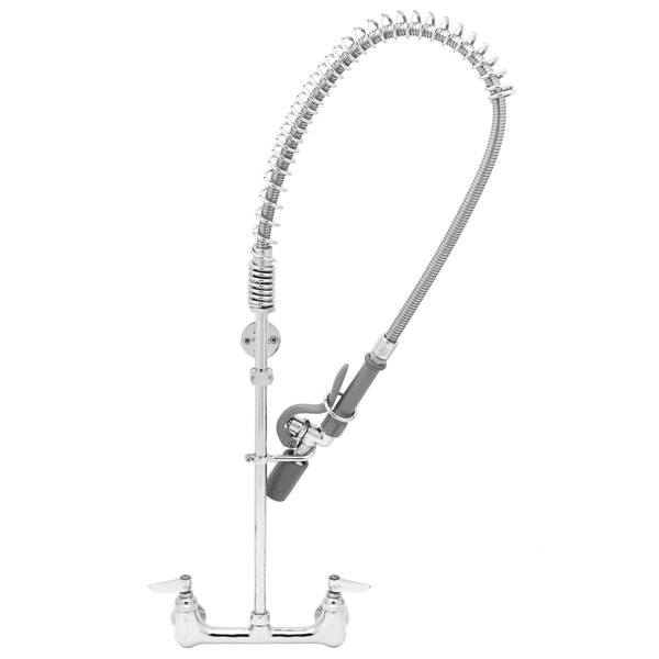 A silver T&S wall mounted pre-rinse faucet with a curved hose.