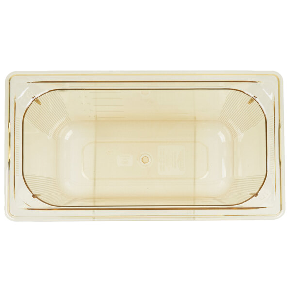 A white rectangular Vollrath plastic food pan with a circle in the middle.
