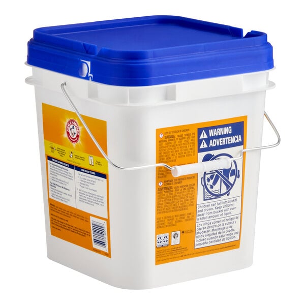 A white plastic container with a blue lid and metal handle, labeled as Arm & Hammer 18 lb. Free & Clear Powder Detergent.