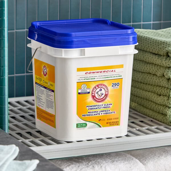 A large white plastic container of Arm & Hammer Free & Clear powder detergent with a blue lid.