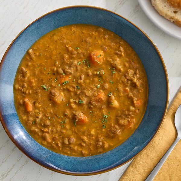 A bowl of Moroccan inspired lentil soup with visible lentils and vegetables.