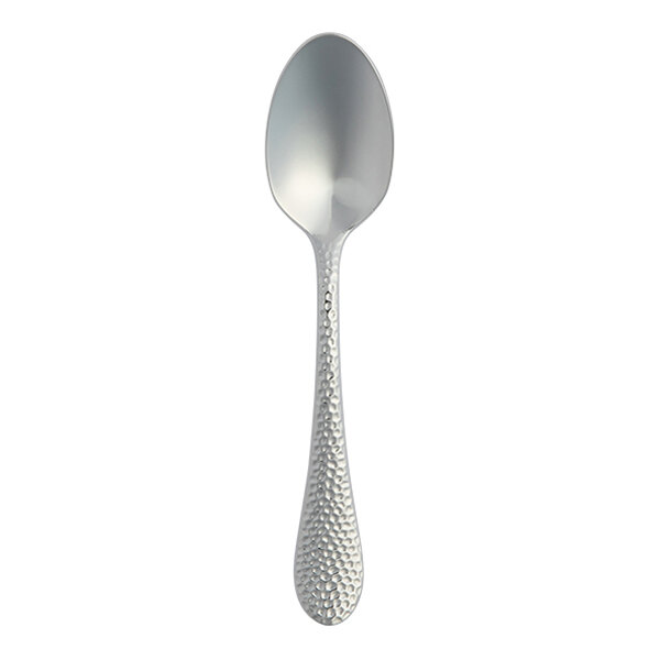 A stainless steel demitasse spoon with a textured handle.