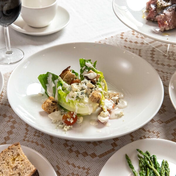 Tuxton Midtown AlumaTux 9 5/8" Pearl White China Coupe Plate - 24/Case
