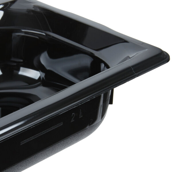 A Vollrath black plastic food pan with a lid.