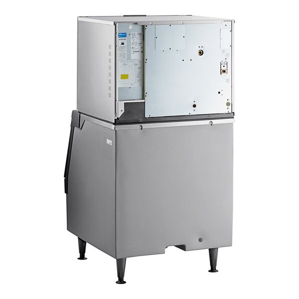 A commercial water-cooled ice machine with a plastic storage bin.