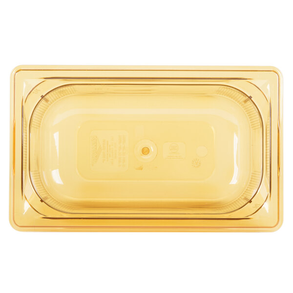 A yellow plastic Vollrath food pan with a lid.