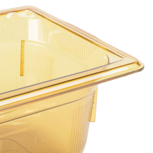 A Vollrath amber plastic food pan with a lid.
