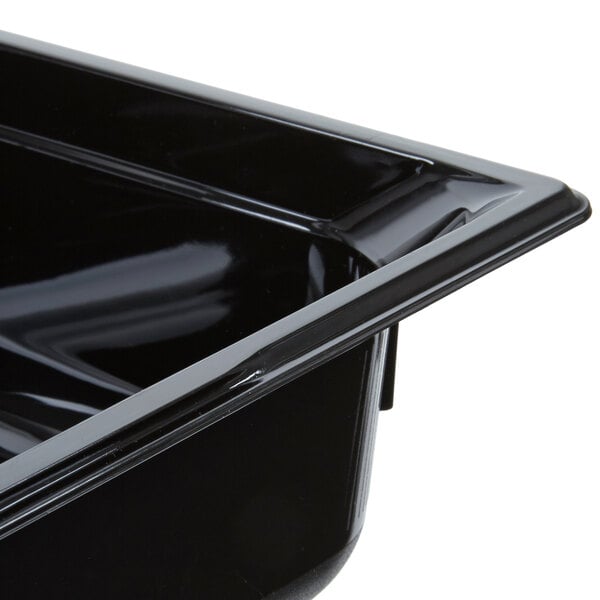 A black plastic Vollrath food pan with a lid on it.