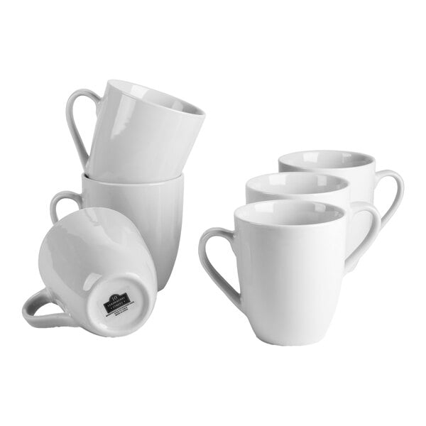 A set of six white porcelain mugs with handles.