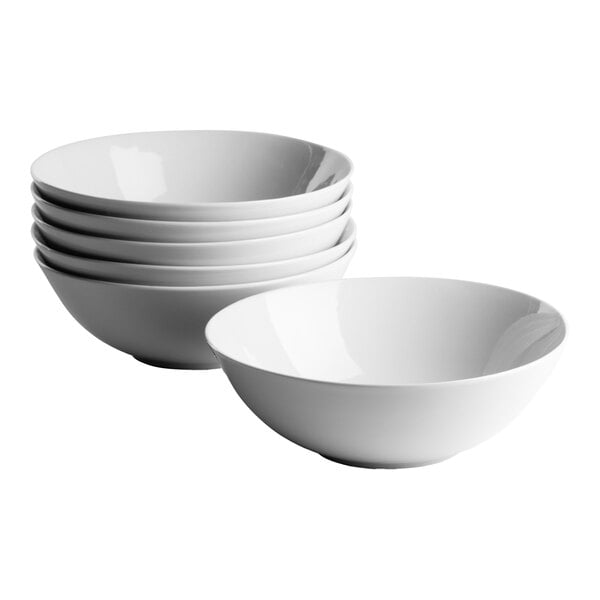 A set of six round white porcelain cereal bowls.