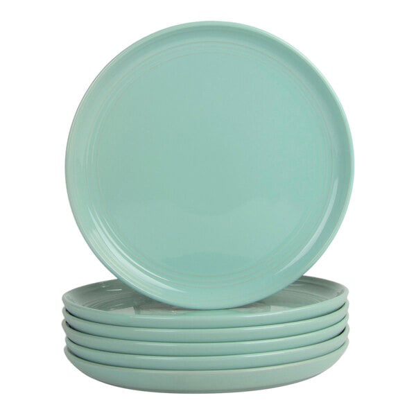 A set of six round seafoam-colored stoneware salad plates.