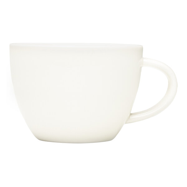 A round white porcelain cup with a handle.