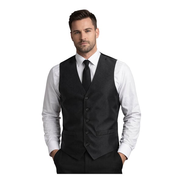 A men's large black brocade diamond pattern server vest with buttons, worn over a white dress shirt and black tie.