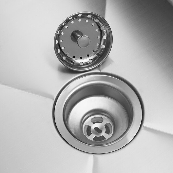 A stainless steel commercial sink drain with a removable strainer basket.