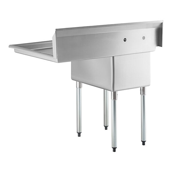 A stainless steel commercial sink with four metal legs, a single deep basin, a high backsplash, and an attached right-side drainboard.