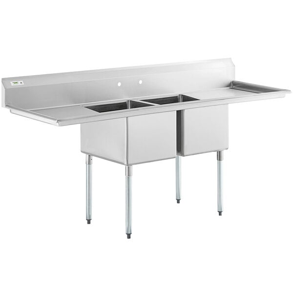 A large stainless steel two-compartment commercial sink with two drainboards and galvanized steel legs.