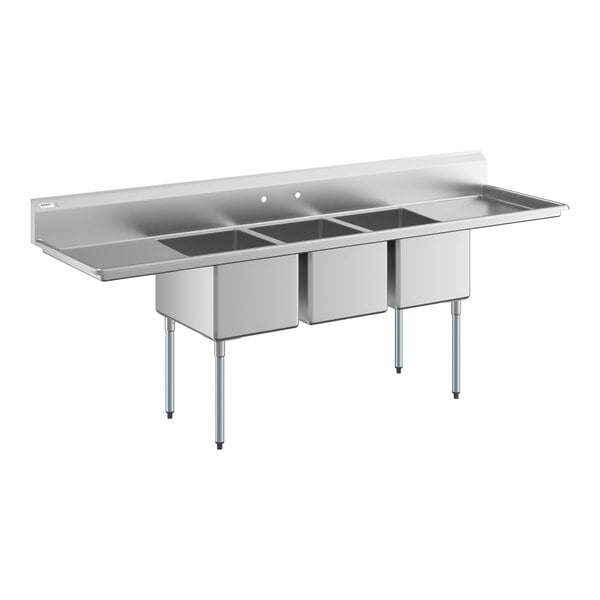 A large stainless steel sink with three deep compartments, two side drainboards, and four metal legs.