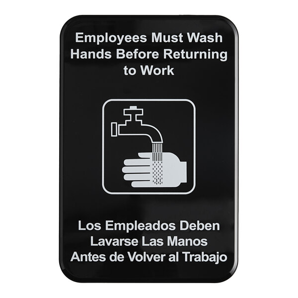 A black and white sign with English and Spanish text instructing employees to wash their hands before returning to work.