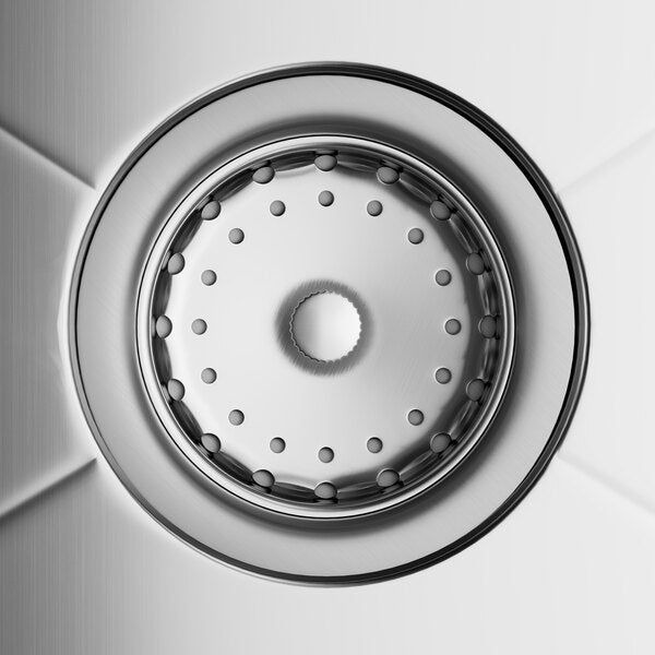 A stainless steel commercial sink drain viewed from above, featuring a circular strainer and smooth metallic finish.